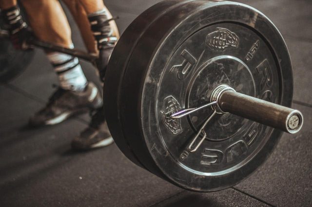 Loaded barbell resting on the floor of the Muscle Up Cooee gym