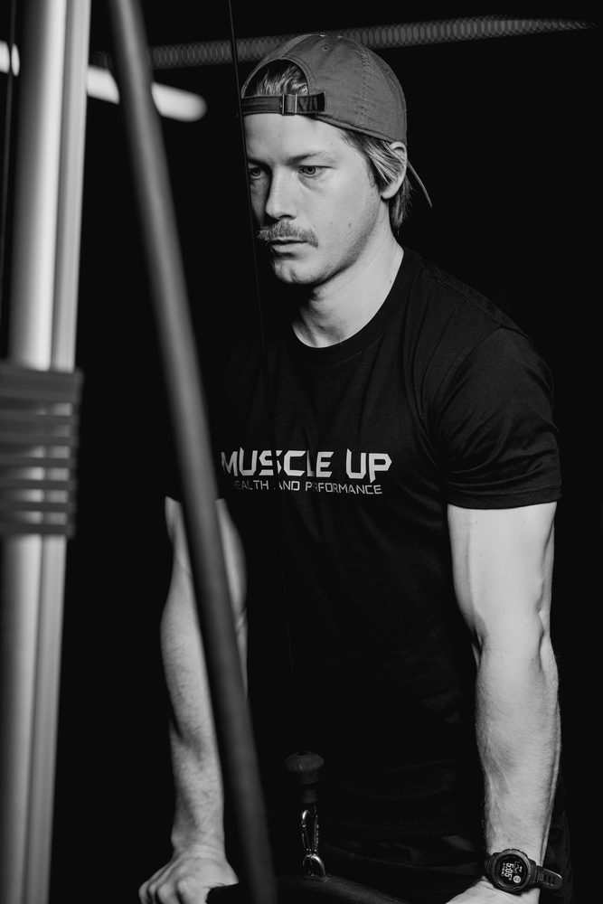 A member in a backwards cap training on a cable machine